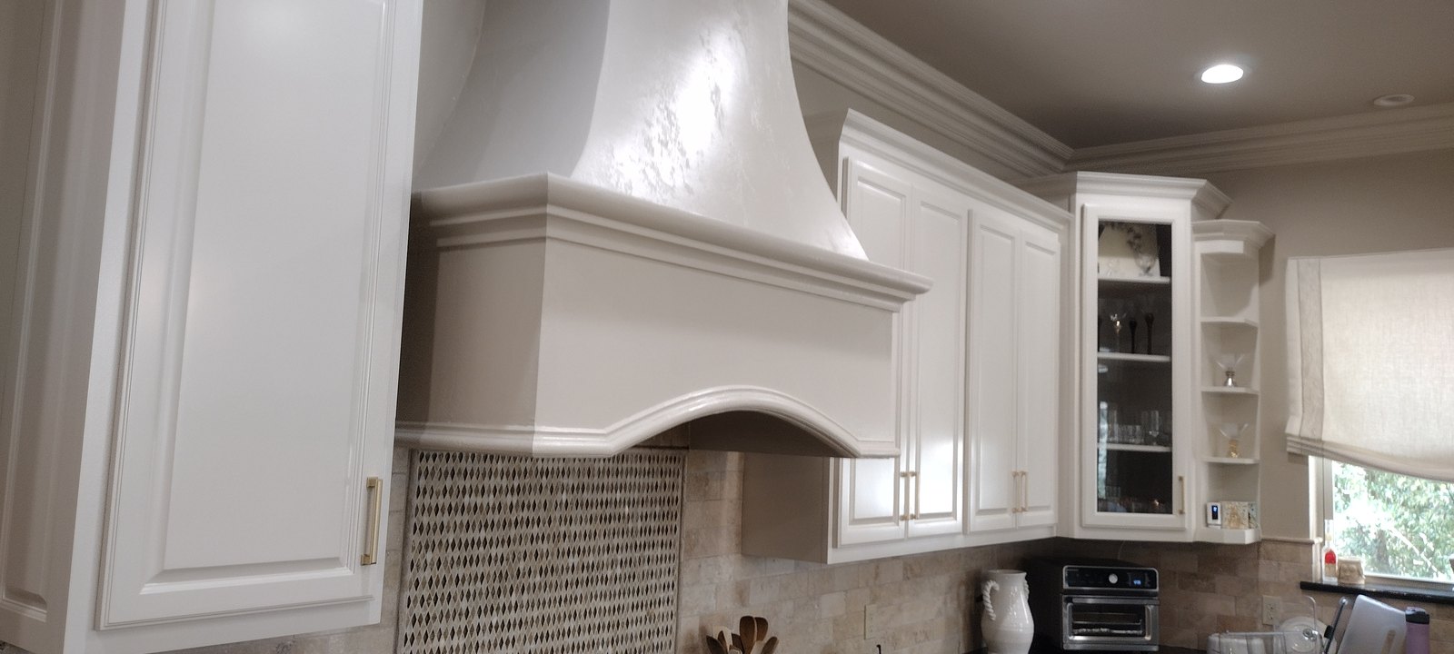 Detail of a refinished carved cabinetry range hood