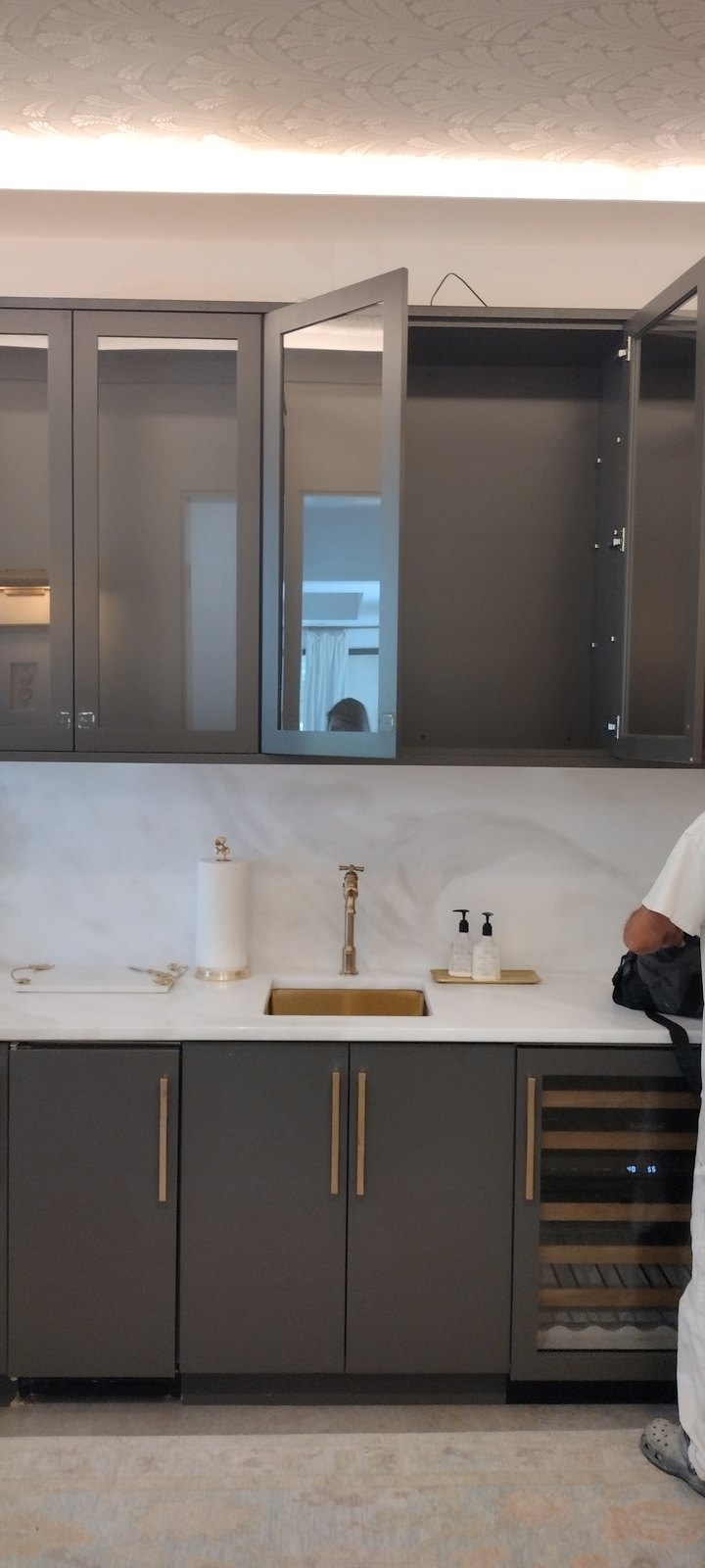 Refinished cabinetry with marble countertop and wine storage tower