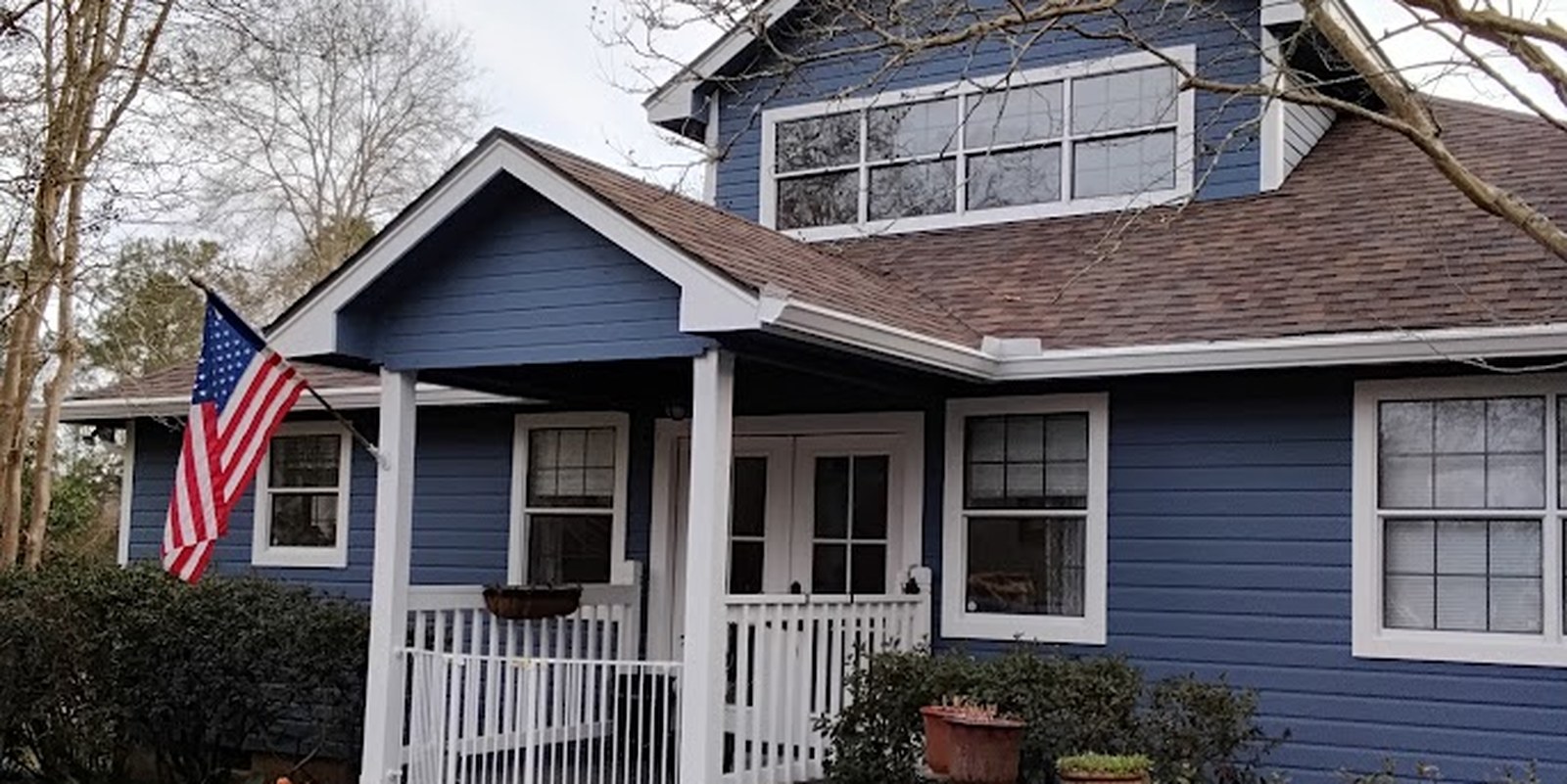 The home repainted a deep navy blue with crisp white trim